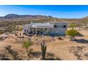 Expansive desert home featuring a neutral color palette, well-designed patio, and a backdrop of mountains at 13502 E Jomax Rd # 123, Scottsdale, AZ 85262