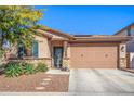 Charming single-story home featuring a desert landscape, a two-car garage, and a stone-accented facade at 14296 W Surrey Dr, Surprise, AZ 85379