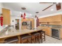 Bright kitchen with a granite countertop island, wooden cabinets, stainless steel appliances, and pendant lighting at 1541 E Hope St, Mesa, AZ 85203