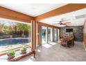 Sunlit living room with tile flooring, large windows with pool views, and a decorative stone accent wall at 1541 E Hope St, Mesa, AZ 85203