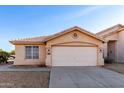 Charming single-story home featuring a neutral stucco facade, tile roof and well-maintained landscaping at 15601 W Hammond Dr, Goodyear, AZ 85338