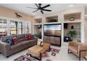 Comfortable living room features built-in shelving, tile flooring, and stylish decor for relaxed living at 16200 W Hearthstone Dr, Surprise, AZ 85374