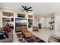 Comfortable living room features built-in shelving, tile flooring, and stylish decor for relaxed living at 16200 W Hearthstone Dr, Surprise, AZ 85374