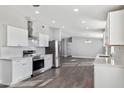 Bright, modern kitchen featuring stainless steel appliances, white cabinetry and light countertops at 1811 N Brower Ln, Maricopa, AZ 85139