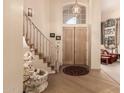 Grand foyer featuring hardwood floors, staircase, high ceilings, and elegant lighting at 1831 W San Angelo St, Gilbert, AZ 85233