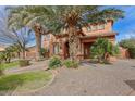 Inviting desert-style home featuring a stone-accented entrance and a well-maintained, low-water landscape at 20396 E Via Del Rancho Rd, Queen Creek, AZ 85142