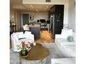 Bright living room featuring plush white seating, a modern coffee table, and an open-concept kitchen at 2300 E Campbell Ave # 204, Phoenix, AZ 85016