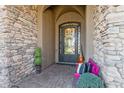 Covered entryway with decorative wrought iron door and stone accents at 23415 S 202Nd St, Queen Creek, AZ 85142