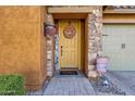 Inviting front entryway with a decorative wreath, stone accents, and a charming welcome sign at 2463 E Stacey Rd, Gilbert, AZ 85298