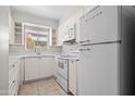 Well-lit kitchen with classic white appliances and ample cabinet space for storage at 3036 N 32Nd St # 314, Phoenix, AZ 85018