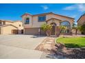 Charming two-story home featuring a spacious driveway and desert landscaping at 31487 N Blackfoot Dr, San Tan Valley, AZ 85143