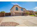 Two story home featuring a large three car driveway and a private fenced in yard at 31487 N Blackfoot Dr, San Tan Valley, AZ 85143