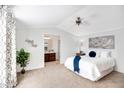 Serene bedroom featuring a plush bed, soft lighting, and a view into the adjacent bathroom at 320 E Mckellips Rd # 227, Mesa, AZ 85201