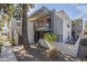 Modern building exterior with a private balcony, lush greenery, and a sleek design, enhancing curb appeal at 3420 W Danbury Dr # C216, Phoenix, AZ 85053