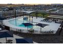 An aerial view of a community pool featuring lounge chairs, umbrellas, and a splash pad at 3508 E Audrey Dr, San Tan Valley, AZ 85143