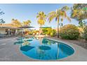 Inviting backyard pool with lounge chairs, umbrellas, and lush landscaping creates a perfect private oasis at 3531 E Becker Ln, Phoenix, AZ 85028