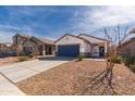 Inviting single-story home with tidy desert landscaping and a two-car garage at 36529 W San Capistrano Ave, Maricopa, AZ 85138