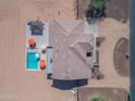 Aerial view of a stunning property featuring a sparkling pool, covered patio and a well-maintained roof at 3707 N 188Th Ave, Litchfield Park, AZ 85340