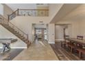 Grand foyer with a staircase, tile flooring, and an open layout leading to the living spaces at 3707 N 188Th Ave, Litchfield Park, AZ 85340