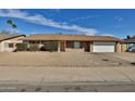 Charming single-story home features a brick facade, gravel landscaping and an attached two-car garage at 4536 W Bloomfield Rd, Glendale, AZ 85304