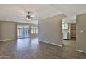 Open-concept living room features wood-look flooring, neutral paint and access to the kitchen at 4536 W Bloomfield Rd, Glendale, AZ 85304