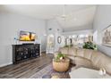 Bright living room featuring vaulted ceilings, hardwood floors, and a stylish leather sectional sofa at 542 S Higley Rd # 83, Mesa, AZ 85206