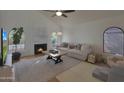 Bright living room featuring a fireplace, large windows and high ceilings at 5518 E Cambridge Ave, Phoenix, AZ 85008