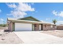 Charming single-story brick home featuring an attached two-car garage and tidy desert landscaping at 6308 E Billings St, Mesa, AZ 85205