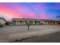 Charming single-story home featuring stylish gray paint, white trim windows, and a low-maintenance rock front yard at 7906 W Catalina Dr, Phoenix, AZ 85033