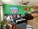 Comfortable living room featuring a plush sofa, colorful artwork, and views of the kitchen at 8732 E Arlington Rd, Scottsdale, AZ 85250