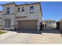 Two-story home with a spacious driveway and a two-car garage, perfect for Gathering living at 9043 E Posada Ave, Mesa, AZ 85212