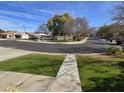 A peaceful neighborhood park with mature shade trees and a covered picnic area under a blue sky at 9043 E Posada Ave, Mesa, AZ 85212