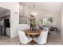 Well-lit dining area features an open layout to the staircase, entry and kitchen at 9812 E Karen Dr, Scottsdale, AZ 85260