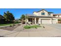 Charming two-story home with a manicured front yard and desert landscaping at 10322 W Edgemont Dr, Avondale, AZ 85392