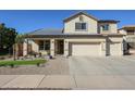 Inviting home featuring a well-manicured yard and solar panels at 10322 W Edgemont Dr, Avondale, AZ 85392