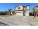 Spacious home featuring a three-car garage and solar panels at 10322 W Edgemont Dr, Avondale, AZ 85392