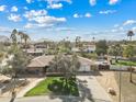 Aerial view of a suburban home with a pool, large backyard, and mature trees in a quiet neighborhood setting at 11420 N 50Th St, Scottsdale, AZ 85254