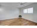 Bright bedroom with wood-look floors, large window, and neutral paint at 1320 E Bethany Home Rd # 24, Phoenix, AZ 85014