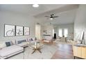 Bright living room featuring vaulted ceilings, modern decor, neutral color palette, and wood flooring at 1320 E Bethany Home Rd # 24, Phoenix, AZ 85014