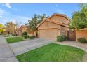 Residential street view featuring well-kept lawns and homes with tile roofs at 16002 N 50Th St, Scottsdale, AZ 85254