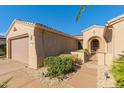 Inviting home exterior featuring a private courtyard and well-maintained landscaping at 16528 W Isleta Ct, Surprise, AZ 85387