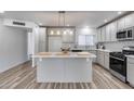 Bright eat-in kitchen featuring an island, modern cabinetry, and stainless steel appliances at 1716 W Butler Dr, Phoenix, AZ 85021