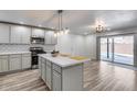 Open kitchen featuring modern cabinets, an island, and sliding glass doors that lead to the pool area at 1716 W Butler Dr, Phoenix, AZ 85021