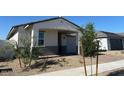 Single-story home with a two-car garage and desert landscaping, offering an inviting curb appeal at 17683 W Odeum Ln, Goodyear, AZ 85338
