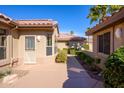 Exterior view featuring a private walkway with desert landscaping and a tiled roof at 19824 N Valencia Ct, Surprise, AZ 85374