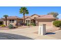 Charming single-story home featuring a tile roof, desert landscaping, and a paved driveway at 19824 N Valencia Ct, Surprise, AZ 85374