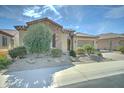Beautifully landscaped single-story home with stone accents and a well-maintained front yard at 26439 W Covey Ln, Buckeye, AZ 85396