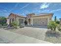 Attractive single-Gathering home with a paver driveway, desert landscaping, and a two-car garage at 26439 W Covey Ln, Buckeye, AZ 85396