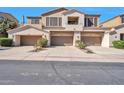 Three-car garage townhome showcasing an appealing neutral exterior with individual balconies and well-manicured landscaping at 3131 E Legacy Dr # 1104, Phoenix, AZ 85042