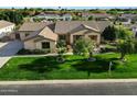Charming single-story home featuring a tile roof, mature landscaping, and a green lawn at 3531 E Norwood Cir, Mesa, AZ 85213
